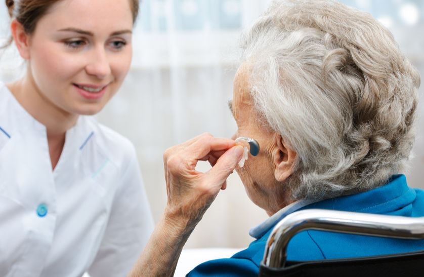 a senior woman with hearing aid